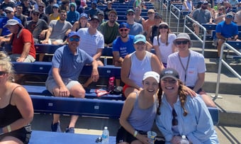 Quantum Workplace employees seated in the bleachers at the College World Series.