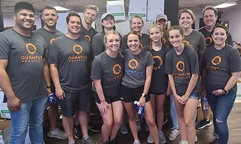 14 Quantum Workplace employees volunteering at a food bank
