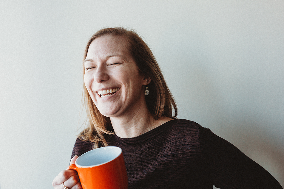 Quantum Workplace employee smiling with a coffee mug