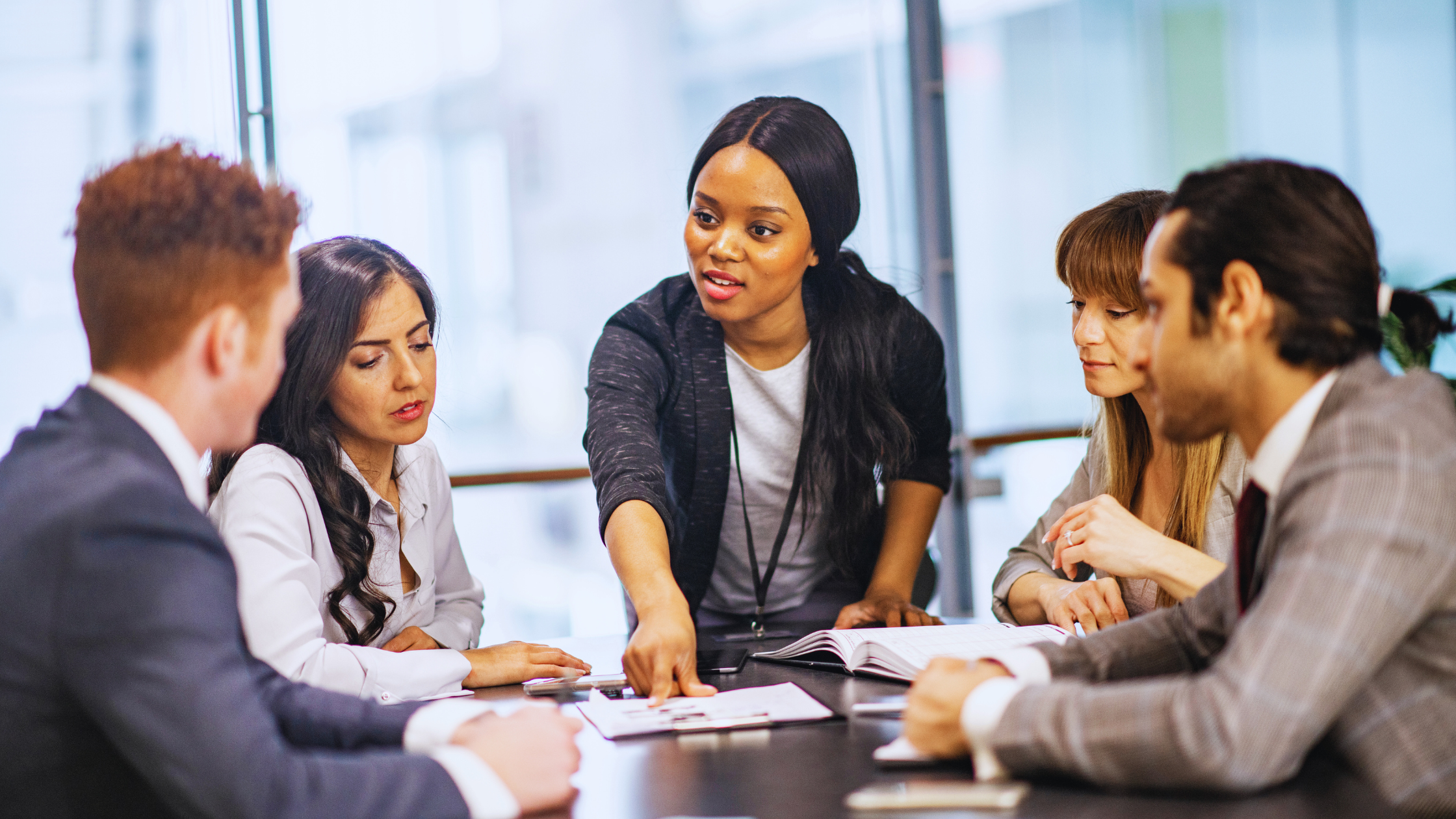 Manager leading team meeting to build stability during organizational change