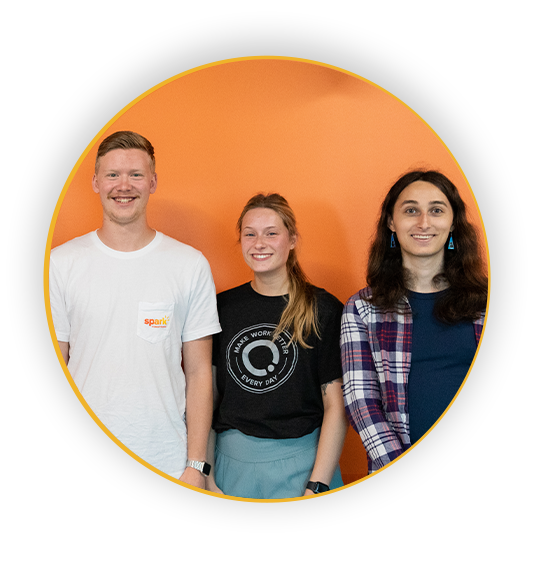 Three interns smiling and looking at the camera