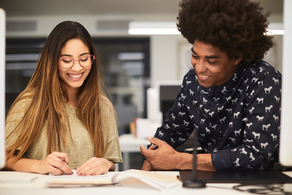 Two coworkers collaborating while looking at papers